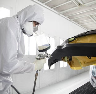 Collision Center Technician Painting a Vehicle | Swickard Toyota 101 in Redwood City CA
